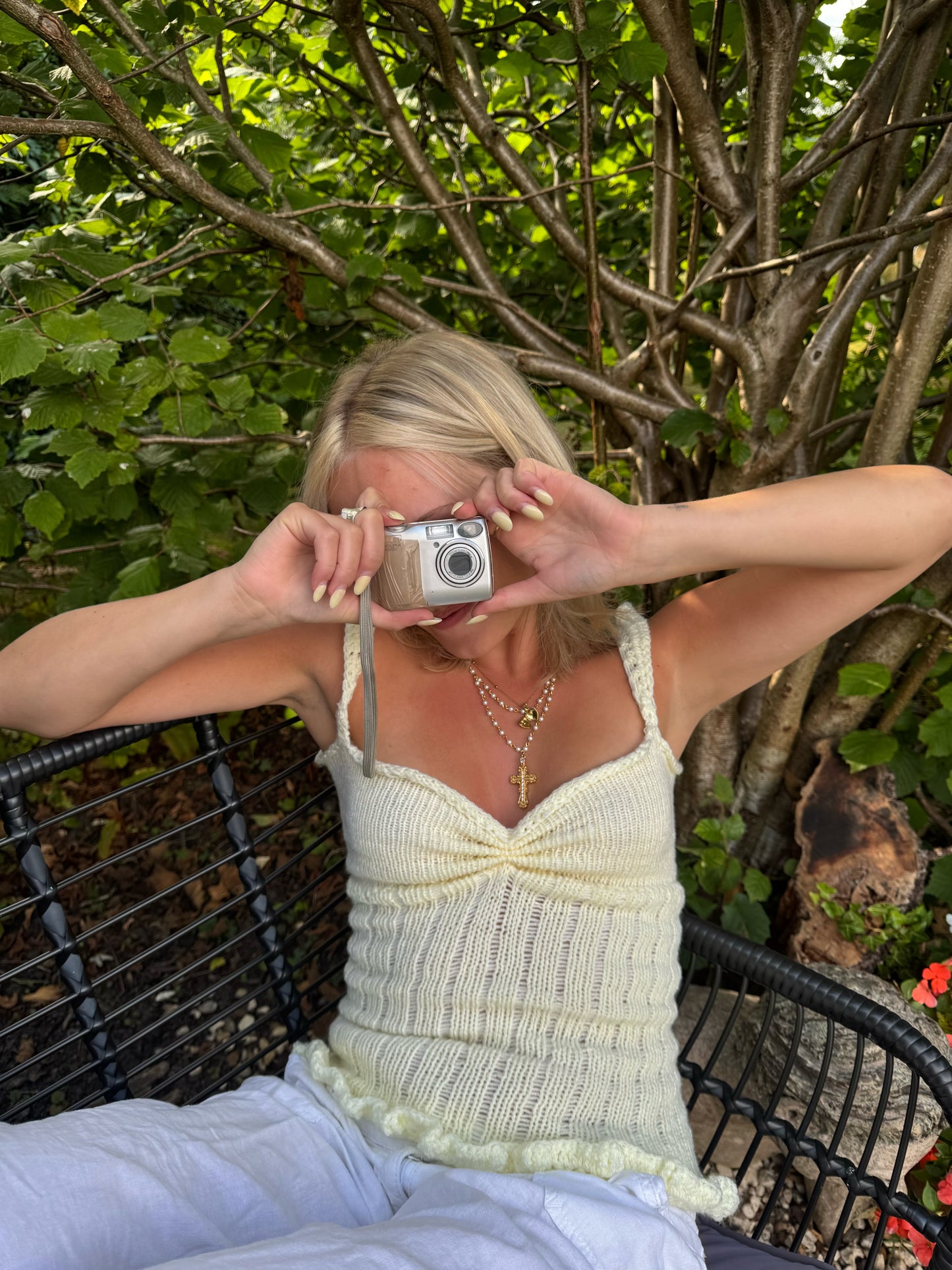 Woman taking a photo with a vintage camera outdoors